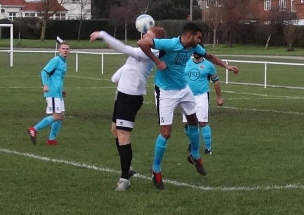 Bexhill United forward Zack McEniry in the thick of the action during last weekend's win over AFC Varndeanians. Picture courtesy Mark Killy