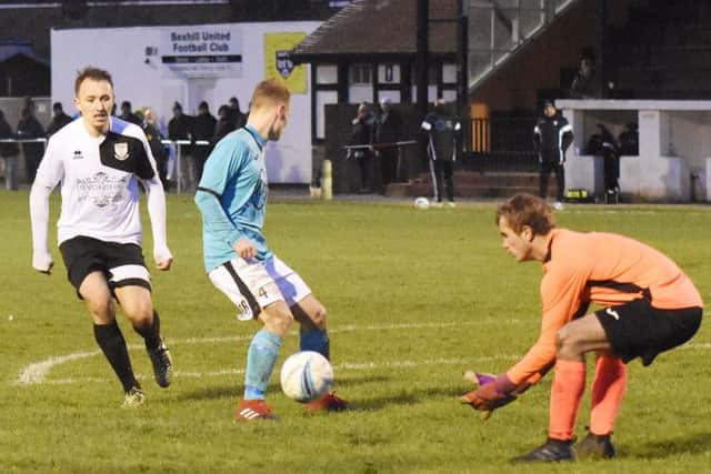 The Varndeanians goalkeeper gathers the ball with Bexhill United's Gordon Cuddington in close attendance. Picture courtesy Jon Smalldon