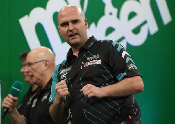 Rob Cross, pictured here at last month's Players Championship Grand Finals, is through to round two of the 2018 William Hill World Darts Championship. Picture courtesy Lawrence Lustig/PDC