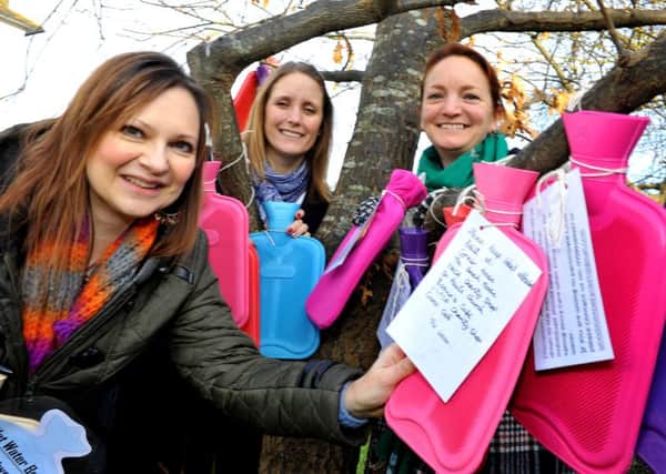 Jane Hartley (left) with others at the hot water bottle tree. Picture: Steve Robards