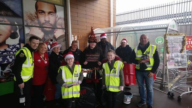 Surviving the Streets UK collecting donations before Christmas with James Robinson on the left
