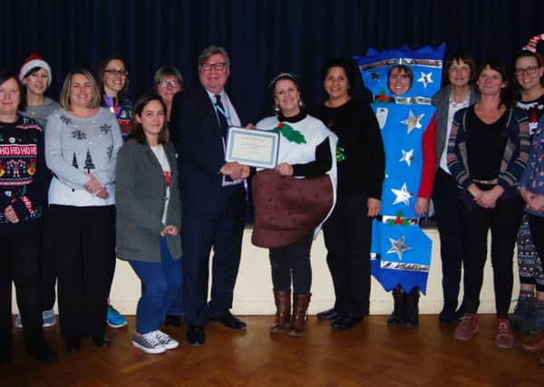 Chairman of East Sussex Healthcare NHS Trust David Clayton-Smith presents the Hastings Health Visiting team with their NHS Trust award. SUS-171219-094613001