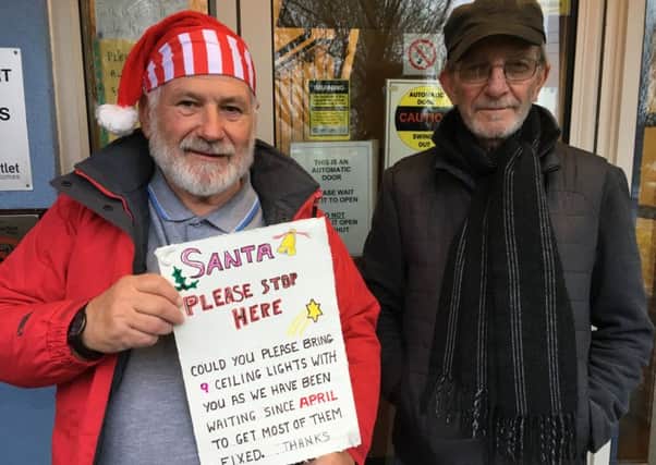 Residents Ray Stenning (dressed as Santa with one of the signs) and John Hostler