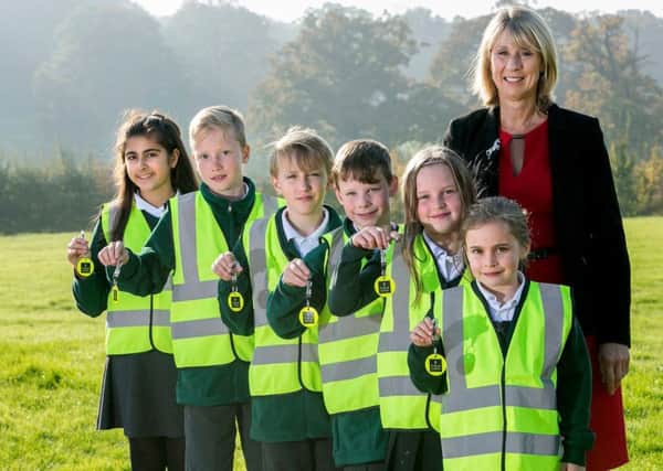 Pupils from Wivelsfield Primary School pupils with their high vis jackets and reflectors donated by CALA homes with headteacher Helen Smith SUS-180901-114459001