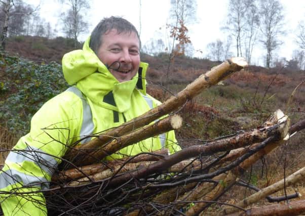 Volunteer Shaun Lynch, from UK Power Networks, working at Sussex Wildlife Trusts Iping and Stedham Commons Nature Reserve.