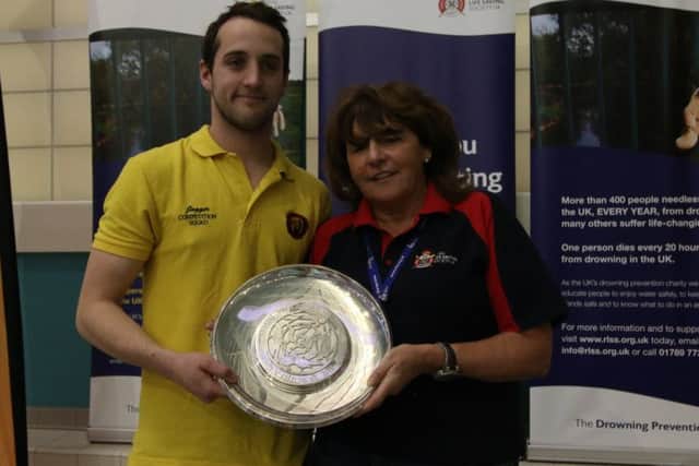 Crawley Town Lifesaving Club's  Richard Jagger being presented with the Cadbury Trophy by RLSS CEO Di Steer. SUS-171219-110945002