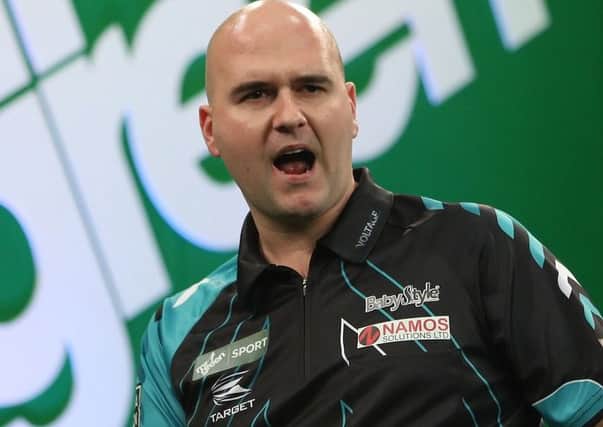 Rob Cross, pictured here at the recent Players Championship Grand Finals, is through to round three of the William Hill World Darts Championship. Picture courtesy Lawrence Lustig/PDC