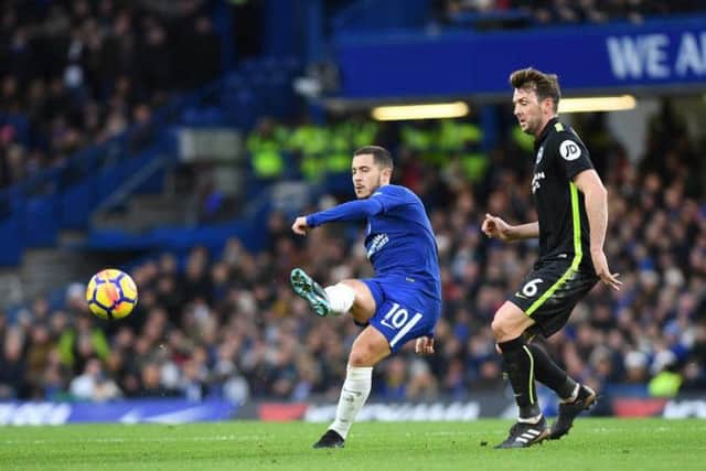 Chelsea midfielder Eden Hazard passes the ball under pressure from Dale Stephens. Picture by Phil Westlake (PW Sporting Photography)