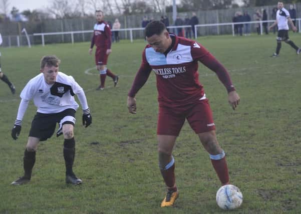 Bexhill United full-back Ben Cornelius keeps a close eye on Little Common midfielder Wes Tate. Pictures by Simon Newstead