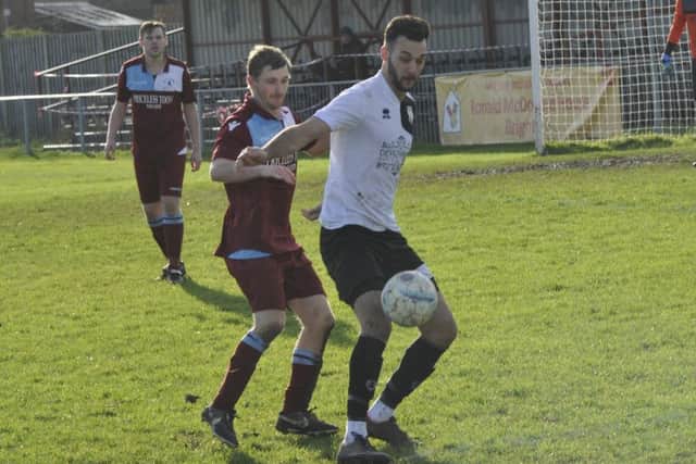 Bexhill United winger Jack McLean shields the ball from Little Common midfielder Adam Smith.
