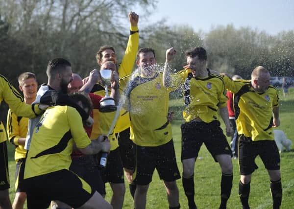 Rye Town celebrate after receiving the Macron East Sussex Football League Division One trophy back in April. Picture by Simon Newstead