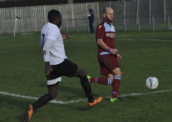 Little Common player-manager Russell Eldridge blocks the path of Bexhill United wide player Georges Gouet. Pictures by Simon Newstead
