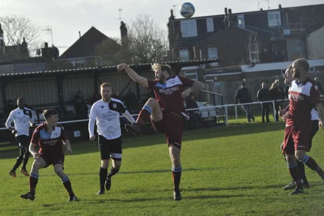 Little Common full-back Ryan Paul clears a Bexhill United free kick.