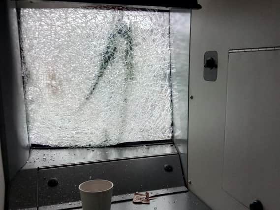 The smashed windscreen of the train after it hit a large tree on the line.