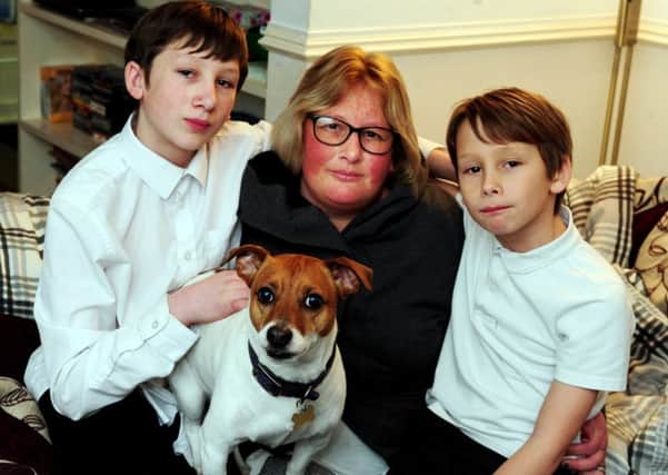 Cheryl Smith with her sons Harry and Taylor have been putting up with a leaking home for nearly a month. Pictures: Kate Shemilt