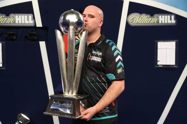 Rob Cross kisses the trophy after winning the 2018 William Hill World Darts Championship. Picture courtesy Lawrence Lustig/PDC