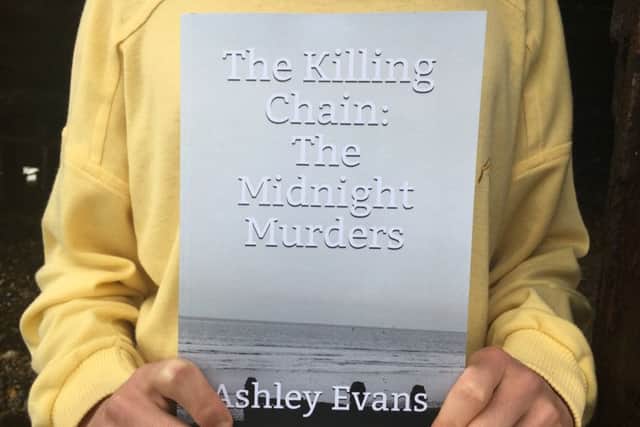Ashley Evans, 17, from Goring with his murder novel The Killing Chain: The Midnight Murders under Worthing Pier, where one of the victims is found