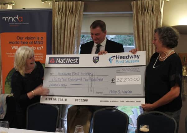 Michele Fleming from Headway East Sussex receiving the cheque from Haywards Heath Golf Club SUS-180301-150455001