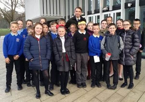 Joe Neale, Schoolsworks lead English teacher, with children from River Beach Primary School and Edward Bryant School at Chichester Festival Theatre