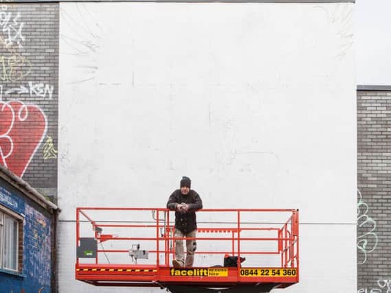 Cosmo Sarson on site where the mural will be unveiled (Credit: James French Photography)