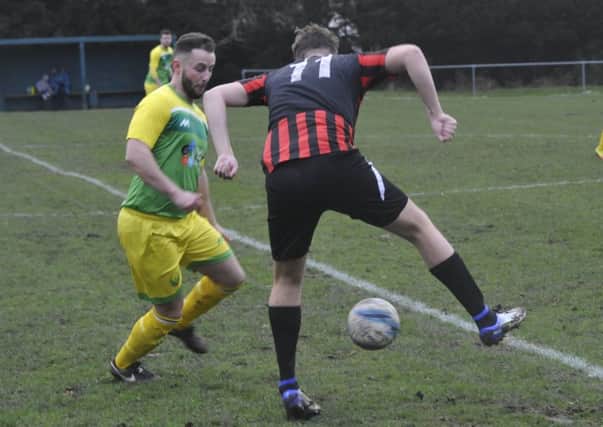 Westfield full-back Ashley O'Prey closes down a Rottingdean Village opponent. Pictures by Simon Newstead