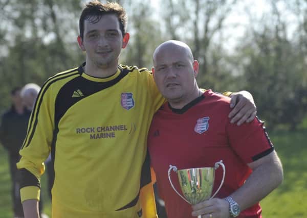 Rye Town captain Sam Henham (left) and manager Shane Ridgers (right) with the Macron East Sussex Football League Division One trophy at the end of last season.