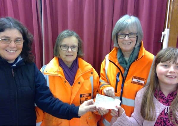 Maureen Payne and Maggie Osgood (centre) from Sussex 4x4 receive cheque from Jac and Laura Young (Christian Voices). SUS-181001-091225001
