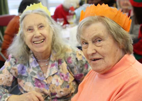 Two smiling guests at New Life Church in Durrington, which hosted a Christmas Lunch for around 70 people who would otherwise spend it alone. Picture: Jamie Peacock