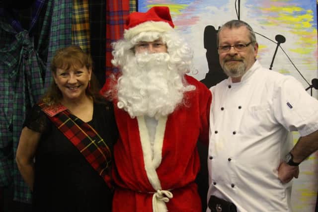 Melody and Colin Pryce from New Life Church in Durrington, pictured with Father Christmas. They organise a Christmas Lunch for people who would otherwise spend it alone each year, and this year's theme was Scottish. Picture: Jamie Peacock