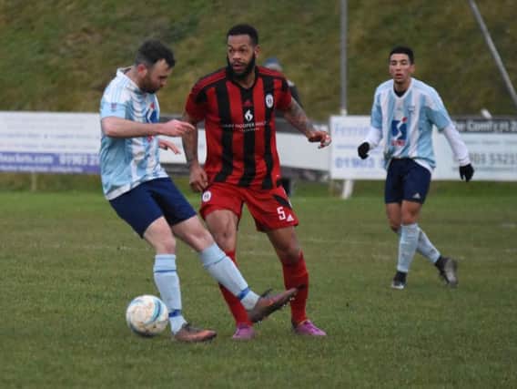 Jahmahl King marks his man closely. Worthing United v Haywards Heath Town. Picture by Grahame Lehkyi