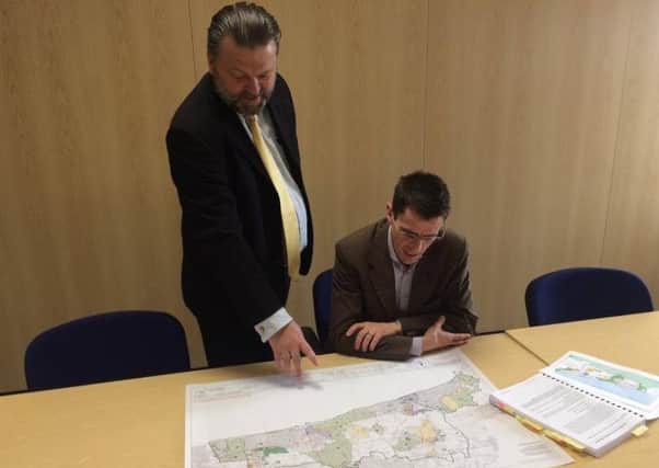 Arun officers Karl Roberts and Neil Crowther inspect a detailed map of the district outlining where housing could be accommodated as part of the local plan SUS-170320-104059001