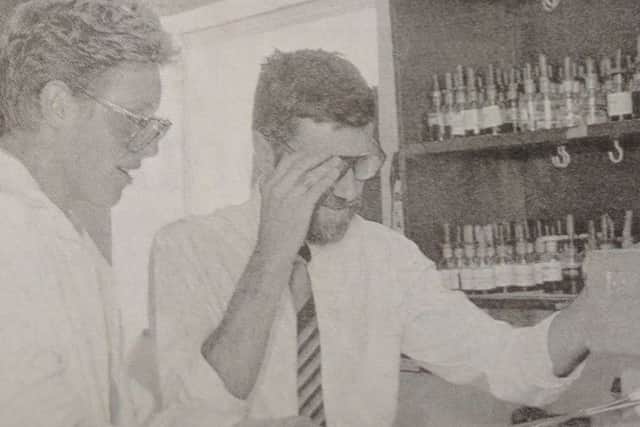 Richard Ellis heats a sample under the watchful eye of chemistry lecturer Mr AG Ross