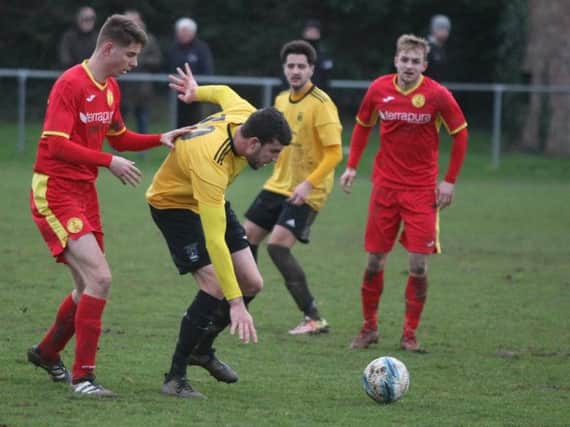Lee Garnham battles for the ball during Golds' home clash with Newhaven on Saturday. Picture by Derek Martin
