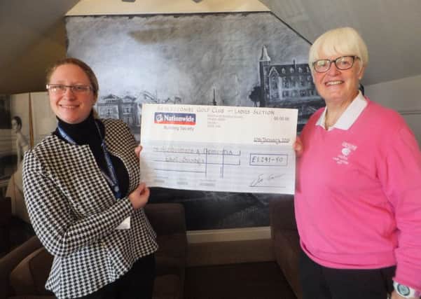 Community Fundraiser Amber Woodward  is presented with a cheque by Sue McGavin at the end of their Charity of the Year Partnership with the Sedlescombe Ladies Golf Club. SUS-180116-100024001
