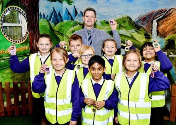 Headteacher Andrew Strong and pupils from Portfield Primary Academy with reflective goodies donated by CALA Homes
