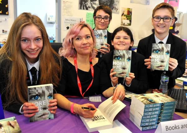Author Kathryn Evans with Durrington High School students at the book-signing session. Picture: Steve Robards SR1801843