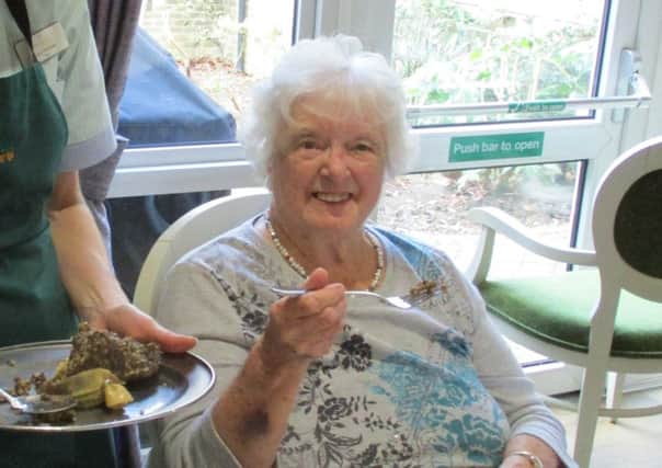 Westlake House care home resident Edith enjoying some haggis SUS-180502-150204001