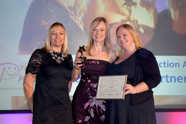 Viki Ashby (centre) and Melissa Baitmansour (right) from i-rock collecting the award in Manchester SUS-181201-150910001