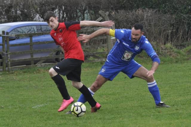 Sidley United captain Chris Copley in the thick of the action against Angmering Seniors.