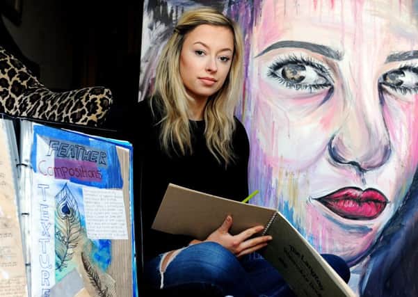 Laine Bolton, 19, from Leconfield Road, Lancing, with one of the recovered paintings and GCSE projects. Picture: Kate Shemilt