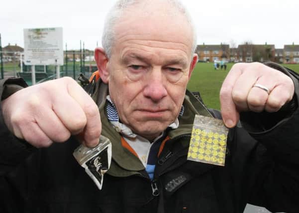 East Preston FC chairman Terry Doyle holding drug packets found on the ground at the recreation ground in Lashmar Road. Photo by Derek Martin Photography