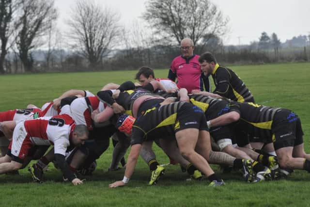 The two sets of forwards battle it out in the scrum.
