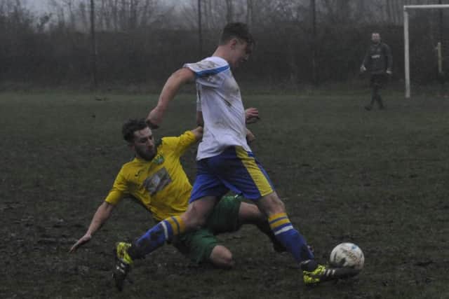 A Westfield second team player slides in on a Northiam 75 opponent.