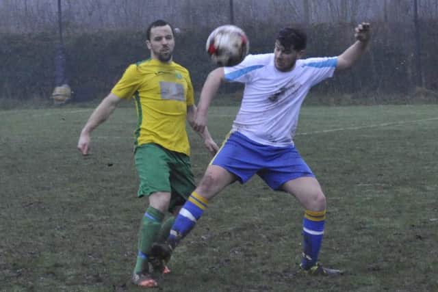 Westfield second team defender Peter Newstead pokes the ball away from a Northiam 75 opponent.