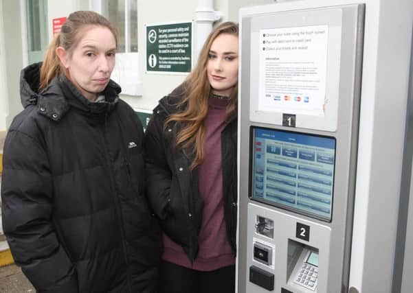 Carmel Olliver and Amy Clark at the ticket machine in Lancing