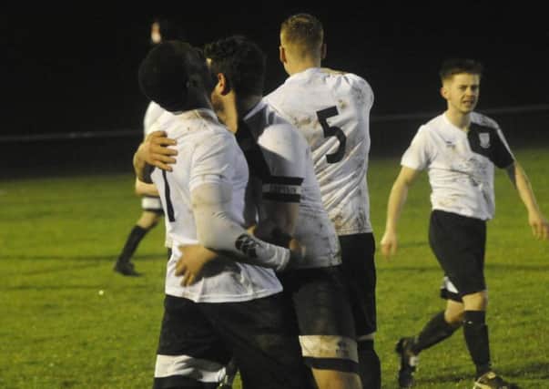 Georges Gouet is congratulated after scoring Bexhill United's third goal. Pictures by Simon Newstead