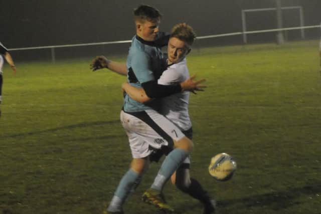Liam Foster gets to grips with an AFC Varndeanians opponent.