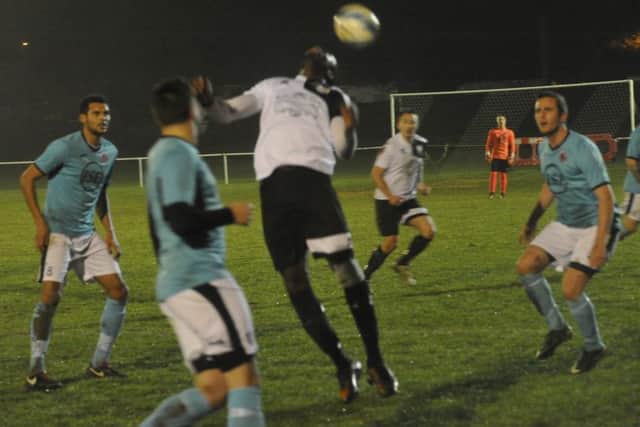 Georges Gouet, scorer of Bexhill United's third goal, flicks the ball on.