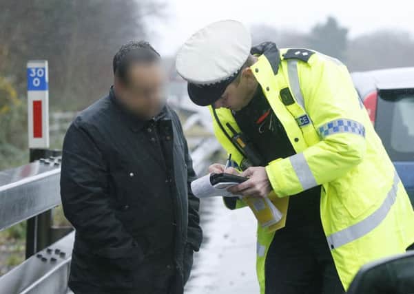 Police talking to a suspect by the roadside. Picture : Habibur Rahman PPP-180124-133816006