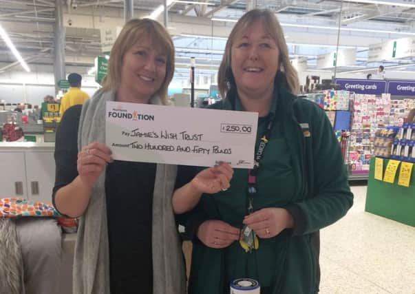 Alison Whitburn, Morrisons Littlehampton community champion, presents Jamie's Wish Trust charity administrator Sue Allen with cheque for Â£250